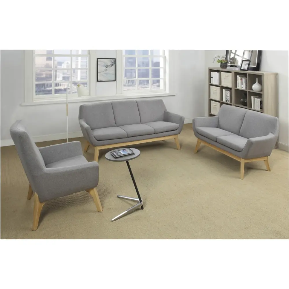 Close-up of a grey upholstered armchair with wooden legs