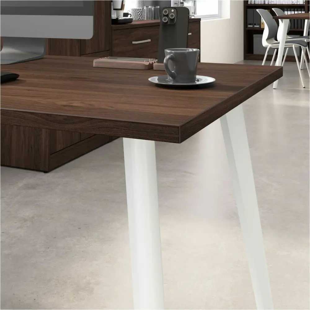 Entire dark wood office desk setup with matching tall cabinet and drawers, in an office scene.