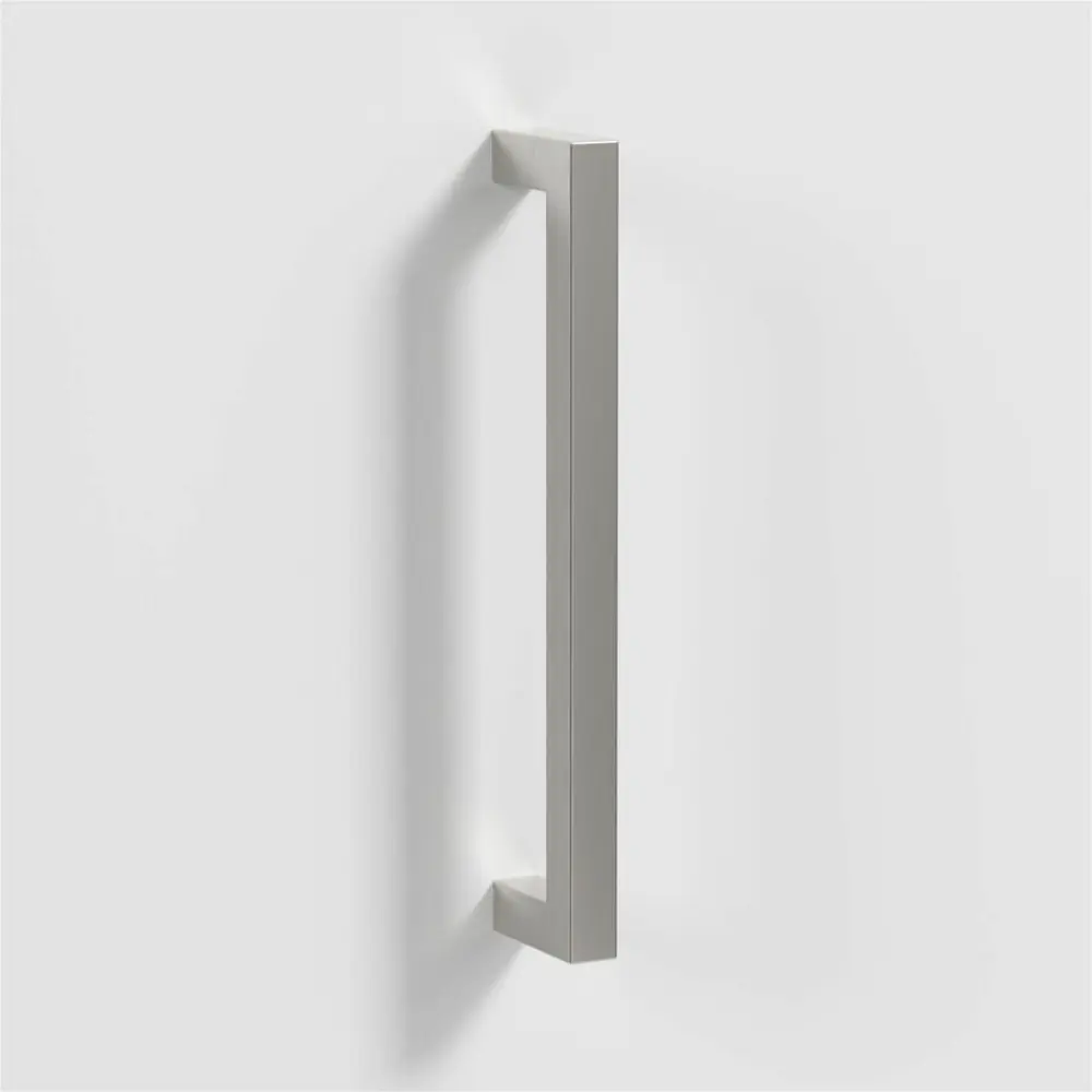 Brushed brass door handle with screws on a white background