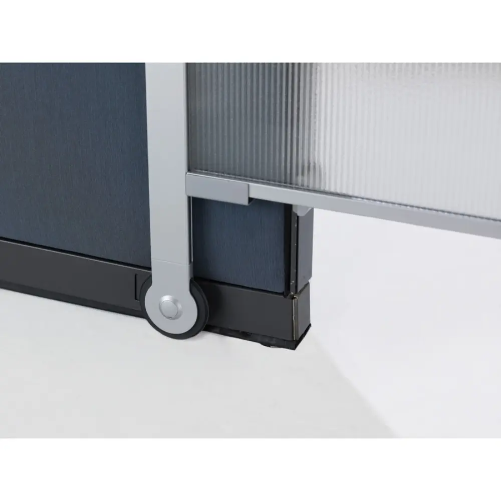 Office cubicles with a person standing near a whiteboard/flip chart