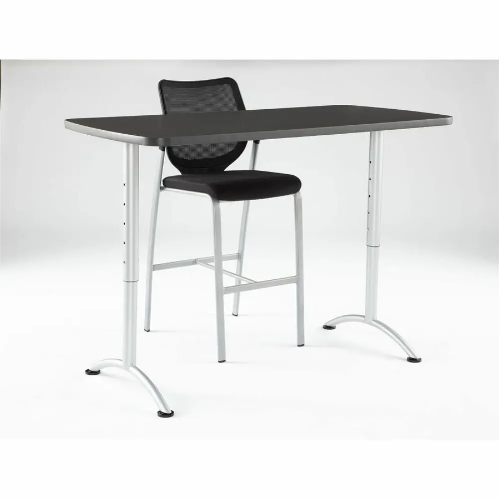 A desk with a dark top and sculpted metal legs, viewed from side.