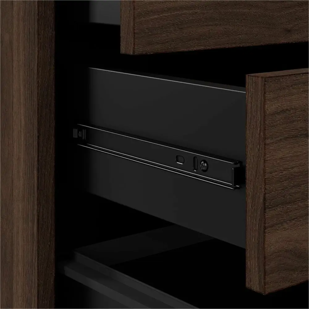 Front view of a brown wood filing cabinet with three drawers and caster wheels