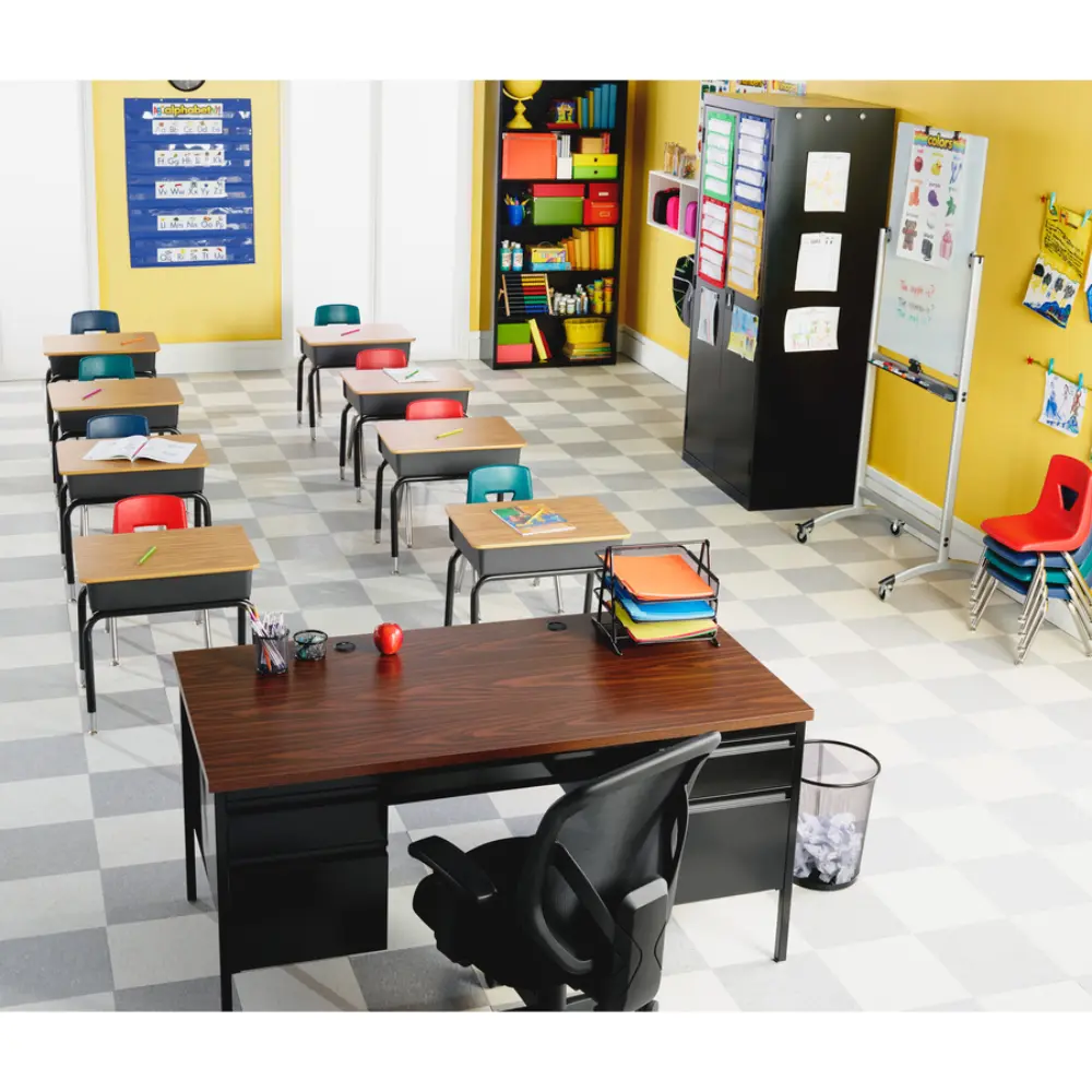 Classroom desks with notebooks and pencils arranged in a row, focusing on a desk in foreground