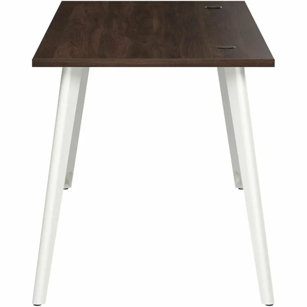 Dark wood desk corner with integrated cable grommet and angled white leg.