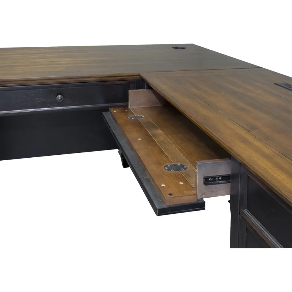 Back panel and drawers of a dark wood desk with metal hardware.