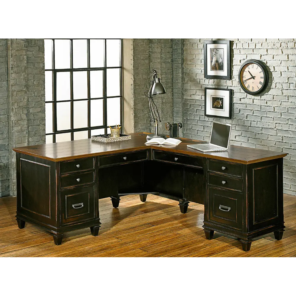 A dark wood desk with multiple drawers and a light wood top, viewed from the side.