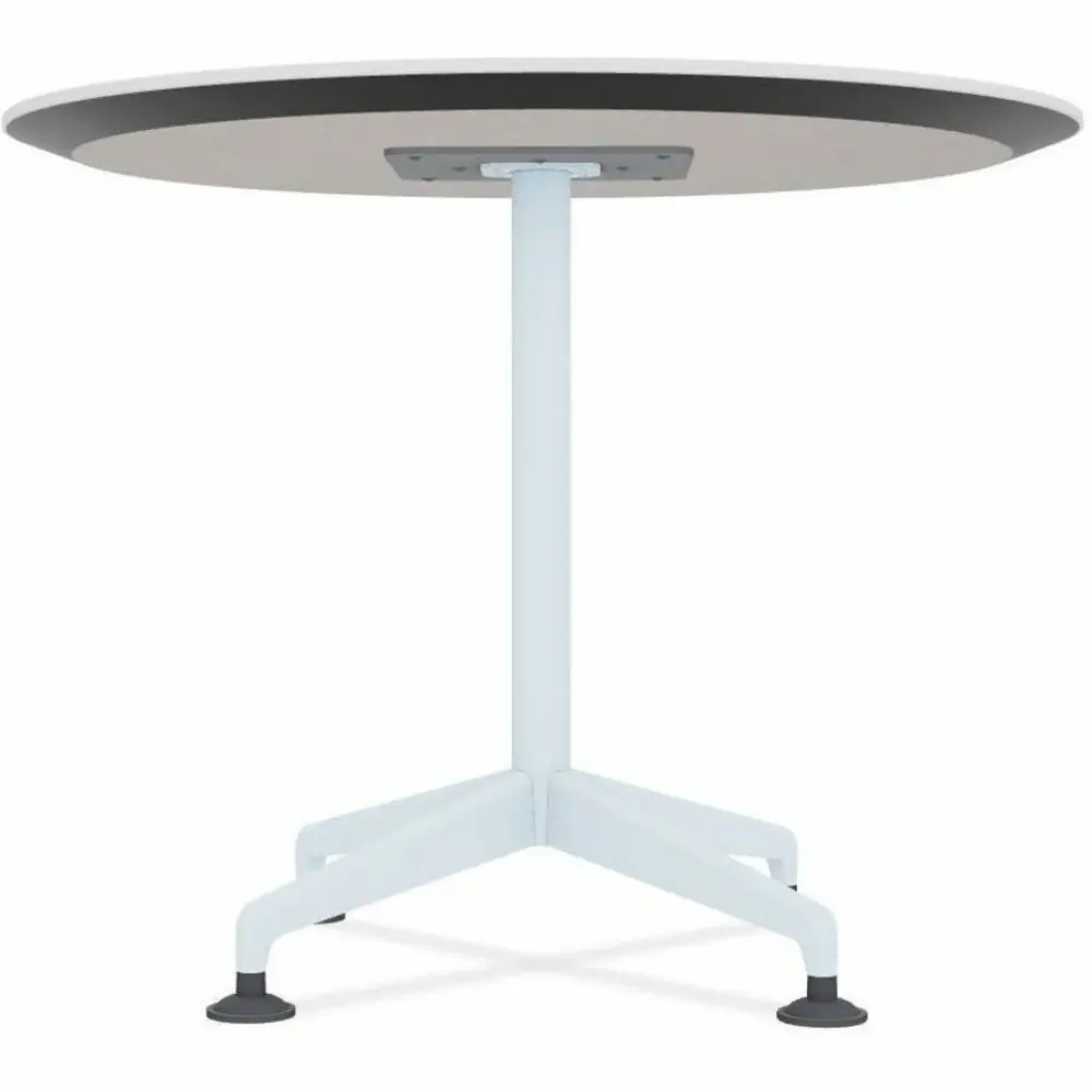 Round white table with pedestal leg and four-pronged base