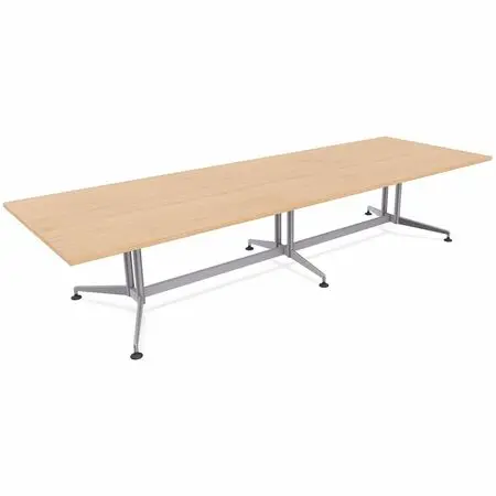 Long conference table with three chairs around it in an office setting