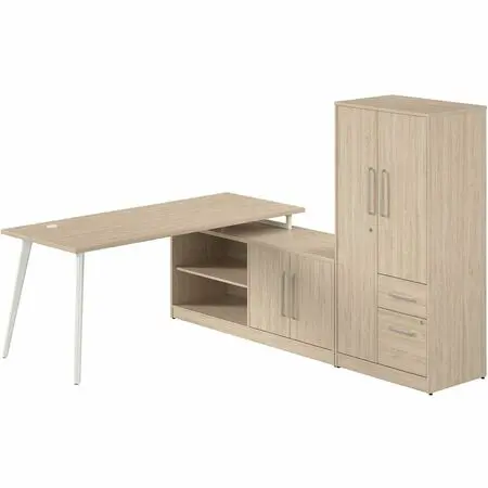 A modern office desk setup with a light wood desk, white metal legs, a black office chair, a matching cabinet and tall storage unit in a bright office space.